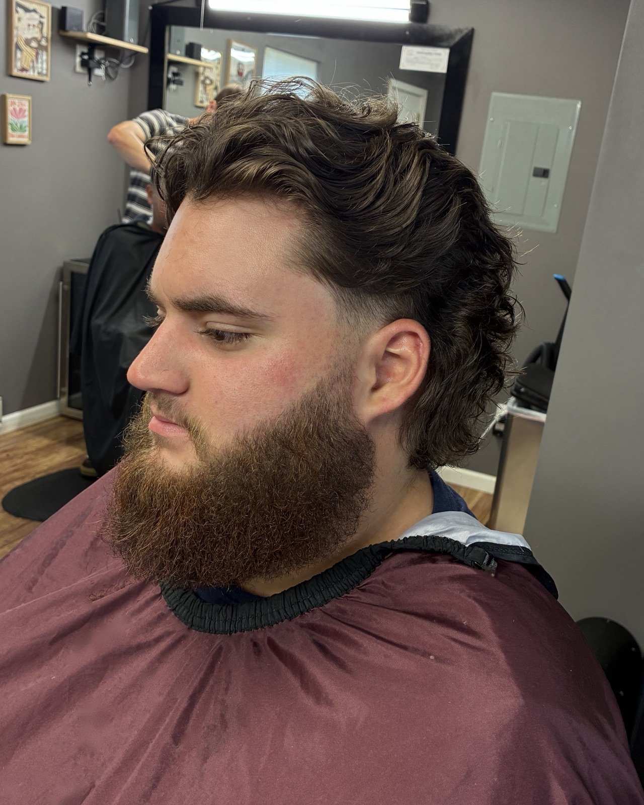 Textured long cut with a full beard at Slick & Steel